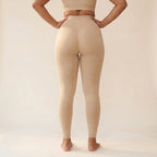 Elya beige tummy control leggings, back view with hands on hips — shape and support, seamless high waist